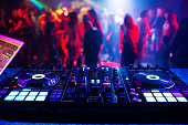 music controller DJ mixer in a nightclub at a party