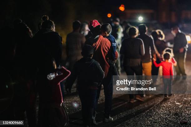 Immigrants seeking asylum walk to be processed and taken to a border patrol processing facility after crossing the Rio Grande into the U.S. On June...