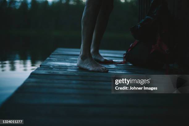 person standing on pier at dusk - bathing jetty stock pictures, royalty-free photos & images