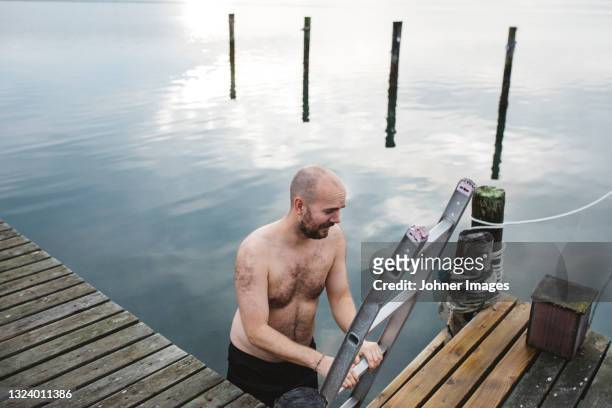 man leaving lake - bathing jetty stock pictures, royalty-free photos & images