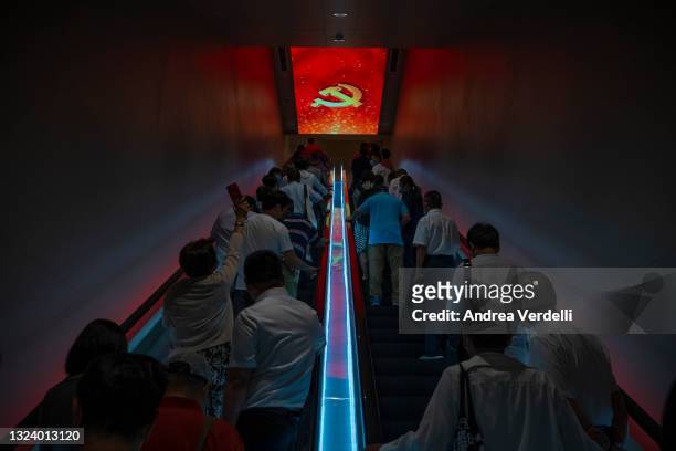 Visitors stand on the escalators on the way out of the Memorial of the First National Congress of the Communist Party of China, on June 17, 2021 in...