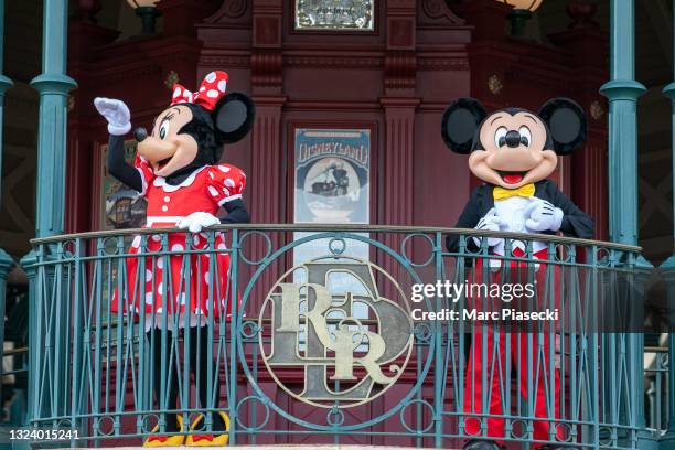 Mickey Mouse and Minnie Mouse wave at first visitors as Disneyland Paris parks reopen on June 17, 2021 in Paris, France.