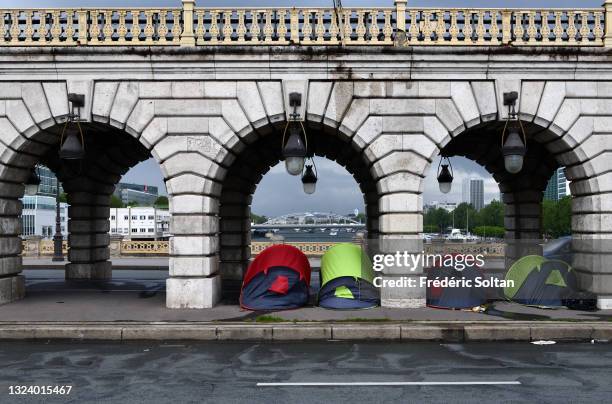 May 19 : Refugees have erected some tents on the bridge of Bercy, stands on the bank of the River Seine in Paris on May 19, 2021 in Paris, France.