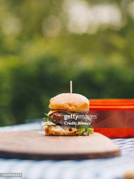 tasty hamburger on chopping board. - cheeseburger grill stock pictures, royalty-free photos & images
