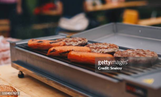 hamburger patties hot dog sausages on grill. - backyard grilling stock pictures, royalty-free photos & images