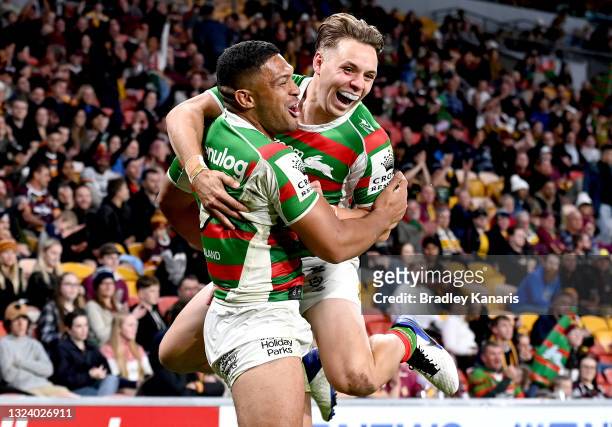 Taane Milne of the Rabbitohs celebrates with team mate Blake Taaffe after scoring a try during the round 15 NRL match between the Brisbane Broncos...