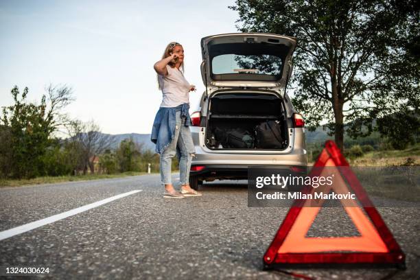 the woman calls the roadside assistance service. - cars on motor way stockfoto's en -beelden