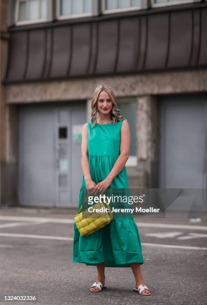 Louisa Theresa Grass wearing green Zero Fashion midi dress, yellow Bottega Veneta leather bag and white Hermes slides on June 03, 2021 in Hamburg,...
