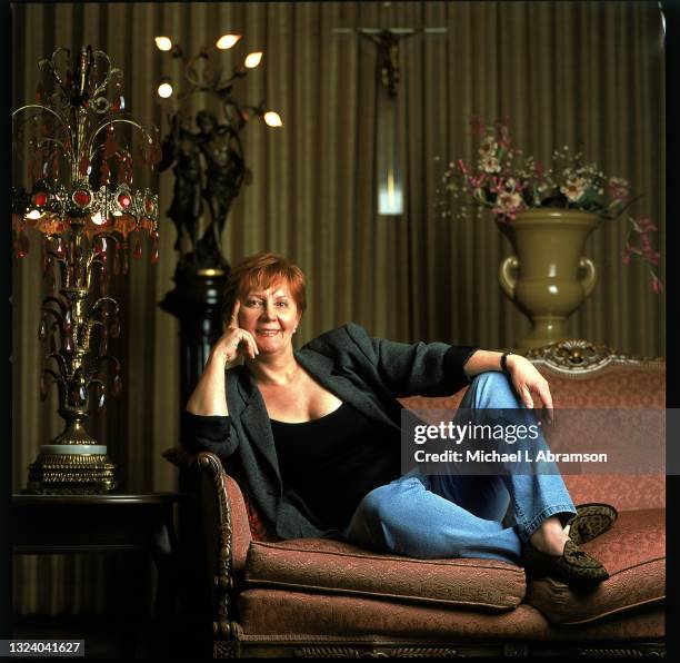 Portrait of American author Janet Evanovich as she sites on a couch at the West Town Funeral Home, Chicago, Illinois, July 2002.