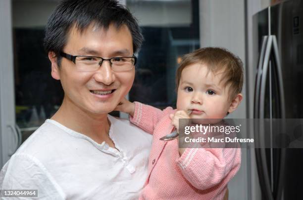 portrait of chinese father and mixed race baby girl - métis stock pictures, royalty-free photos & images