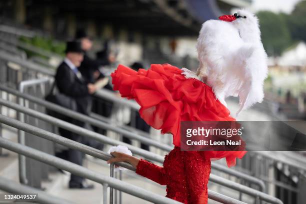 Milliner Debora Day shows off her creation as she walks through the stand at Ascot Racecourse on June 17, 2021 in Ascot, England. Gold Cup Day at the...