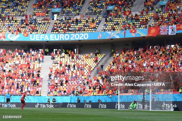 Egzijan Alioski of North Macedonia has a penalty saved by Georgiy Bushchan of Ukraine before scoring their side's first goal from the rebound during...