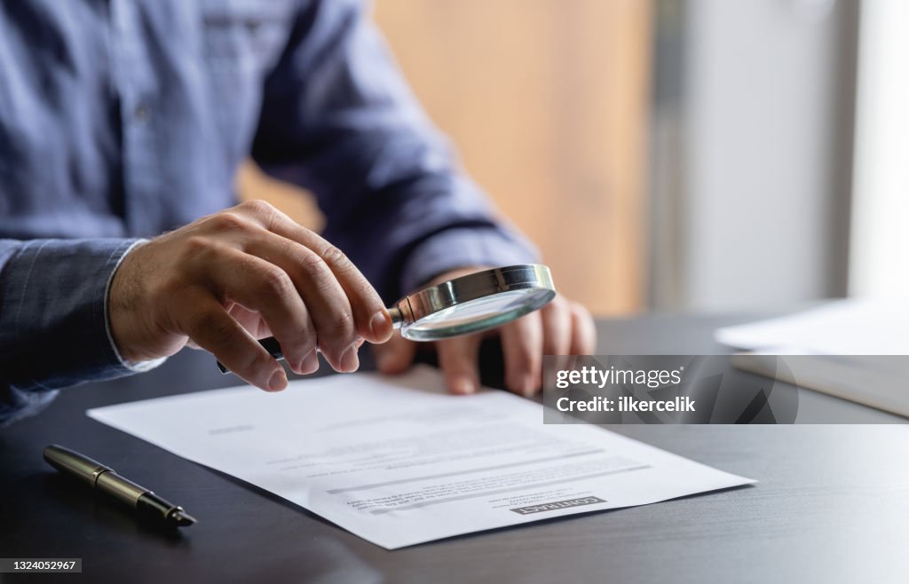 Businessman Signing Legal Paper In Office