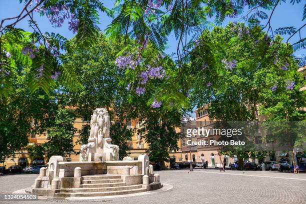 the testaccio square with the fountain of the amphorae in the testaccio district in rome - testaccio roma stock pictures, royalty-free photos & images