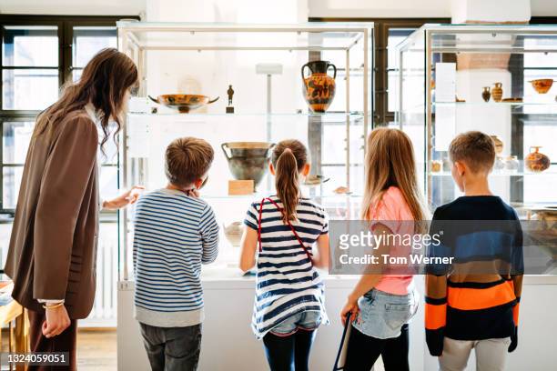 Children Looking At Artifacts In Museum