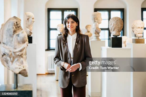 portrait of school teacher standing among classical sculptures in museum - history stock pictures, royalty-free photos & images