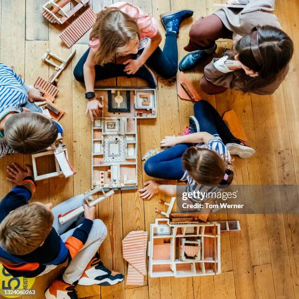 aerial view of kids playing with model house in muesum - children museum stock pictures, royalty-free photos & images