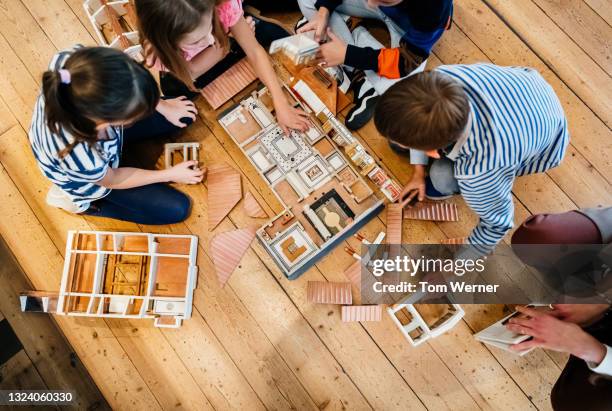 kids playing with model house while visiting museum - model building stock-fotos und bilder