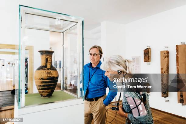 mature couple looking at museum exhibits together - natural history museum stock pictures, royalty-free photos & images
