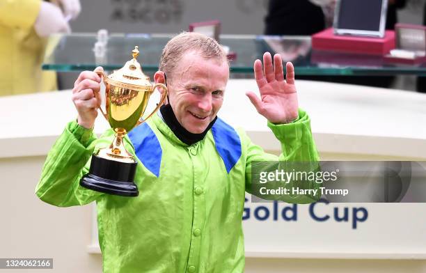 Jockey Joe Fanning celebrates with the Gold Cup after winning on board Subjectivist on Day Three of the Royal Ascot Meeting at Ascot Racecourse on...