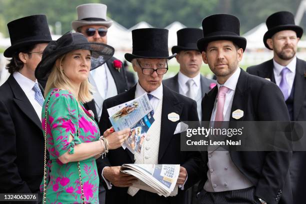 Race-goers consider the betting odds ahead of the Gold Cup race at Ascot Racecourse on June 17, 2021 in Ascot, England. Gold Cup Day at the annual...