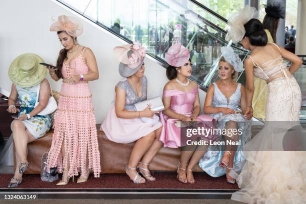 Race-goers rest between events at Ascot Racecourse on June 17, 2021 in Ascot, England. Gold Cup Day at the annual Royal Ascot race meeting has been...
