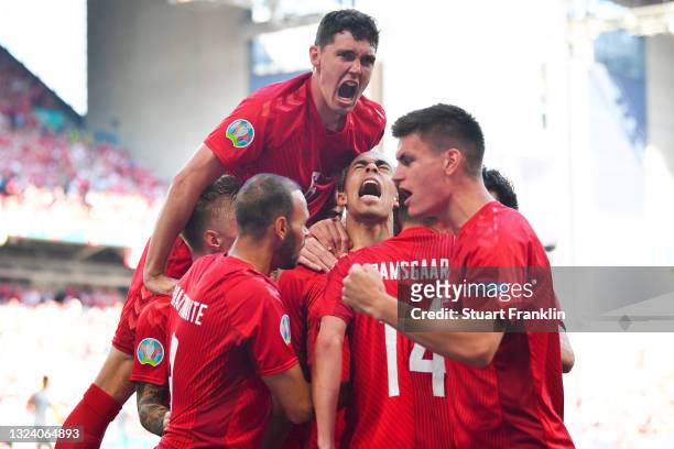 Yussuf Poulsen of Denmark celebrates with team mates after scoring their side's first goal during the UEFA Euro 2020 Championship Group B match...