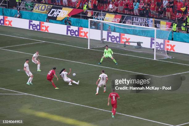 Yussuf Poulsen of Denmark scores their side's first goal past Thibaut Courtois of Belgium during the UEFA Euro 2020 Championship Group B match...