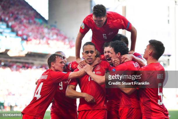 Yussuf Poulsen of Denmark celebrates with team mates after scoring their side's first goal during the UEFA Euro 2020 Championship Group B match...