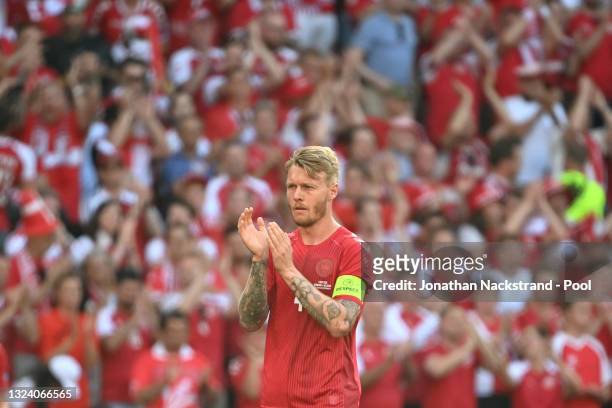 Simon Kjaer of Denmark applauds as the ball is kicked out of play in the tenth minute followed by a minute of applause in support of Denmark...