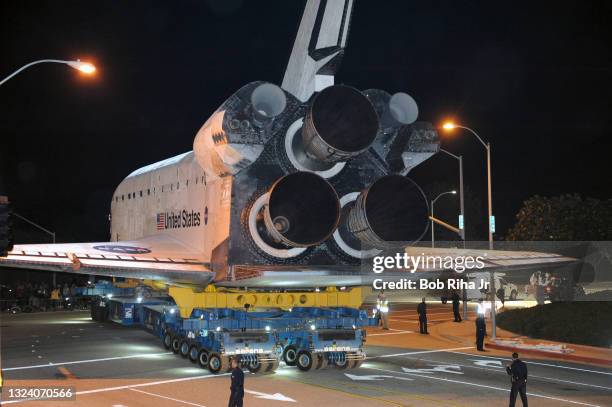 Space Shuttle Orbiter Endeavour begins its early morning, first leg journey being towed through the streets of Los Angeles to California Science...