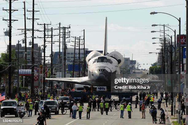 Space Shuttle Orbiter Endeavour travels down Manchester Blvd. To begin the first leg of journey being towed through the streets of Los Angeles to...
