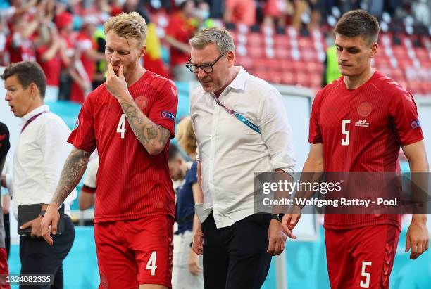 Simon Kjaer and Joakim Maehle of Denmark look dejected as they walk off the pitch with Kasper Hjulmand , Head Coach of Denmark following defeat in...