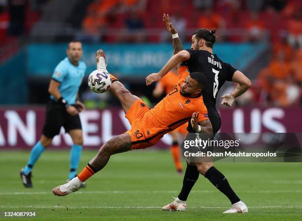 Memphis Depay of Netherlands is challenged by Aleksandar Dragovic of Austria during the UEFA Euro 2020 Championship Group C match between the...