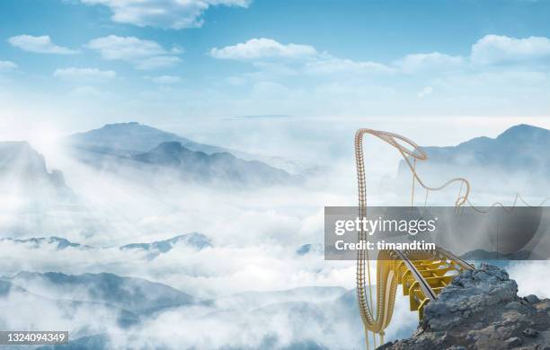 roller coaster at the top of a cliff through a sea of clouds - anticipation rollercoaster stock pictures, royalty-free photos & images