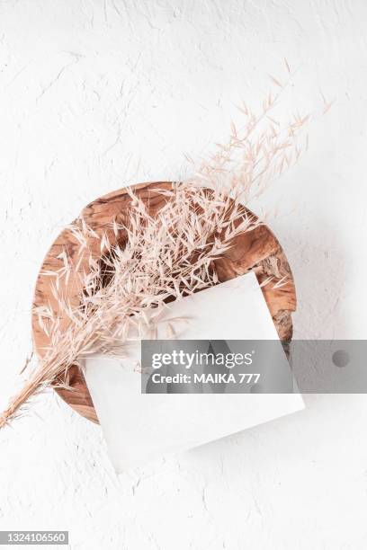 top view, flat lay blank template of a paper card on teak wood bowl with bundle golden wild oat (avena fatua). concept of greeting card for mothers day, wedding, happy event or birthday. - fatua stock pictures, royalty-free photos & images