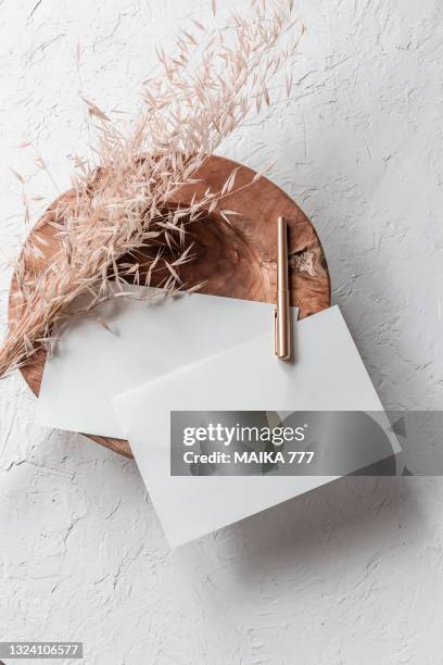top view, flat lay blank template of a paper card and gold pencil on teak wood bowl with bundle golden wild oat (avena fatua). concept of greeting card for mothers day, wedding, happy event or birthday. - fatua stock pictures, royalty-free photos & images