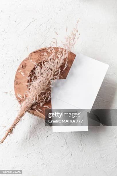 top view, flat lay blank template of a paper card on teak wood bowl with bundle golden wild oat (avena fatua). concept of greeting card for mothers day, wedding, happy event or birthday. - avena fatua stock pictures, royalty-free photos & images