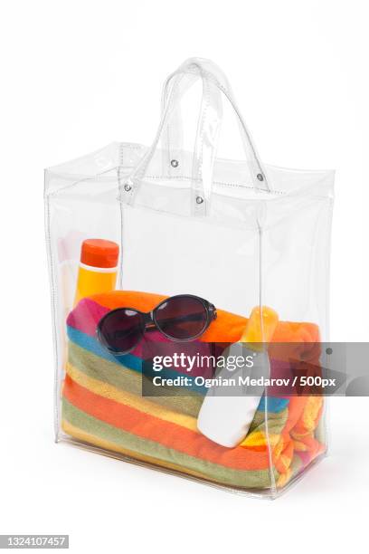 transparent tote bag with beach accessories - transparent bag stock pictures, royalty-free photos & images