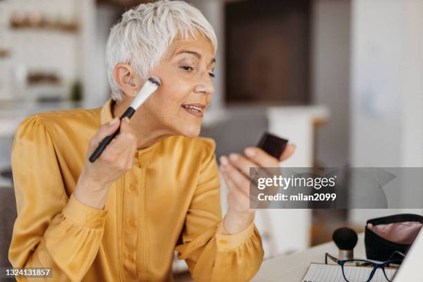 senior woman working from home - woman gray hair mirror stock pictures, royalty-free photos & images