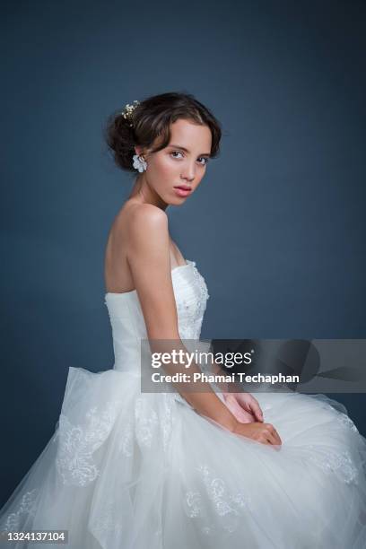 beautiful woman in a white gown - lange jurk stockfoto's en -beelden