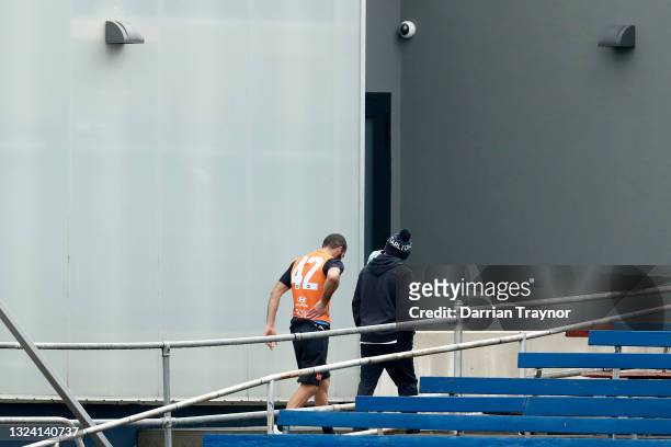 Adam Saad of the Blues leaves the training track early with medical staff during a Carlton Blues AFL training session at Ikon Park on June 18, 2021...