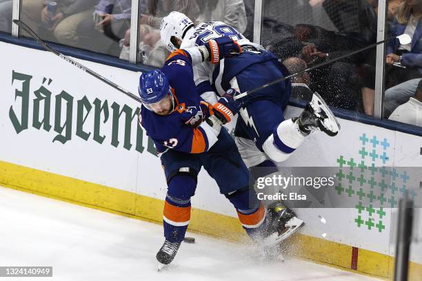 David Savard of the Tampa Bay Lightning is checked into the boards by Casey Cizikas of the New York Islanders during the third period in Game Three...