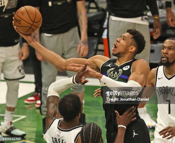 Giannis Antetokounmpo of the Milwaukee Bucks shoots over Jeff Green of the Brooklyn Nets at Fiserv Forum on June 17, 2021 in Milwaukee, Wisconsin....