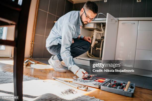 plumber at work - tool belt stock pictures, royalty-free photos & images