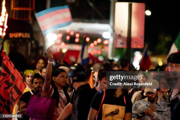 Person waves a transgender pride flag on the one year anniversary of the Black Lives Matter Stonewall Protests near The Stonewall Inn on June 17,...