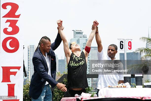 Brian Adams, Takeru Kobayashi and Tyrone Jackson attend Nathan's Famous Hot Dog Eating Contest via satellite at 230 Fifth Avenue on July 4, 2011 in...