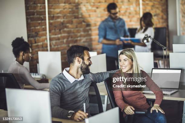 young happy colleagues talking at corporate office. - office romance stock pictures, royalty-free photos & images