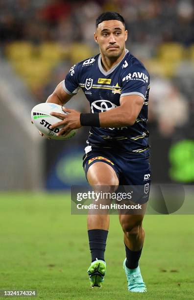 Valentine Holmes of the Cowboys runs the ball during the round 15 NRL match between the North Queensland Cowboys and the Cronulla Sharks at QCB...