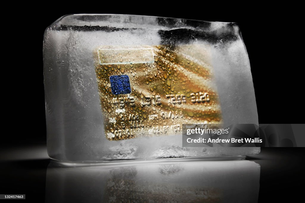 Credit card frozen inside a block of ice